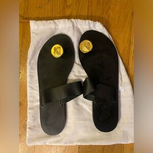 Ancient Greek Sandals slip on black leather flats with gold toe bar